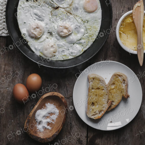 A dish of eggs, bread and sauce laid out on a table. A dish of eggs, bread and sauce laid out on a table.