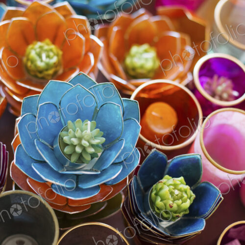 A display of candles and tealight candle holders. Bright colours, retro style.