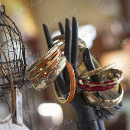 A display of rings and bangles, and objects in an antique store. A display of rings and bangles, and objects in an antique store.