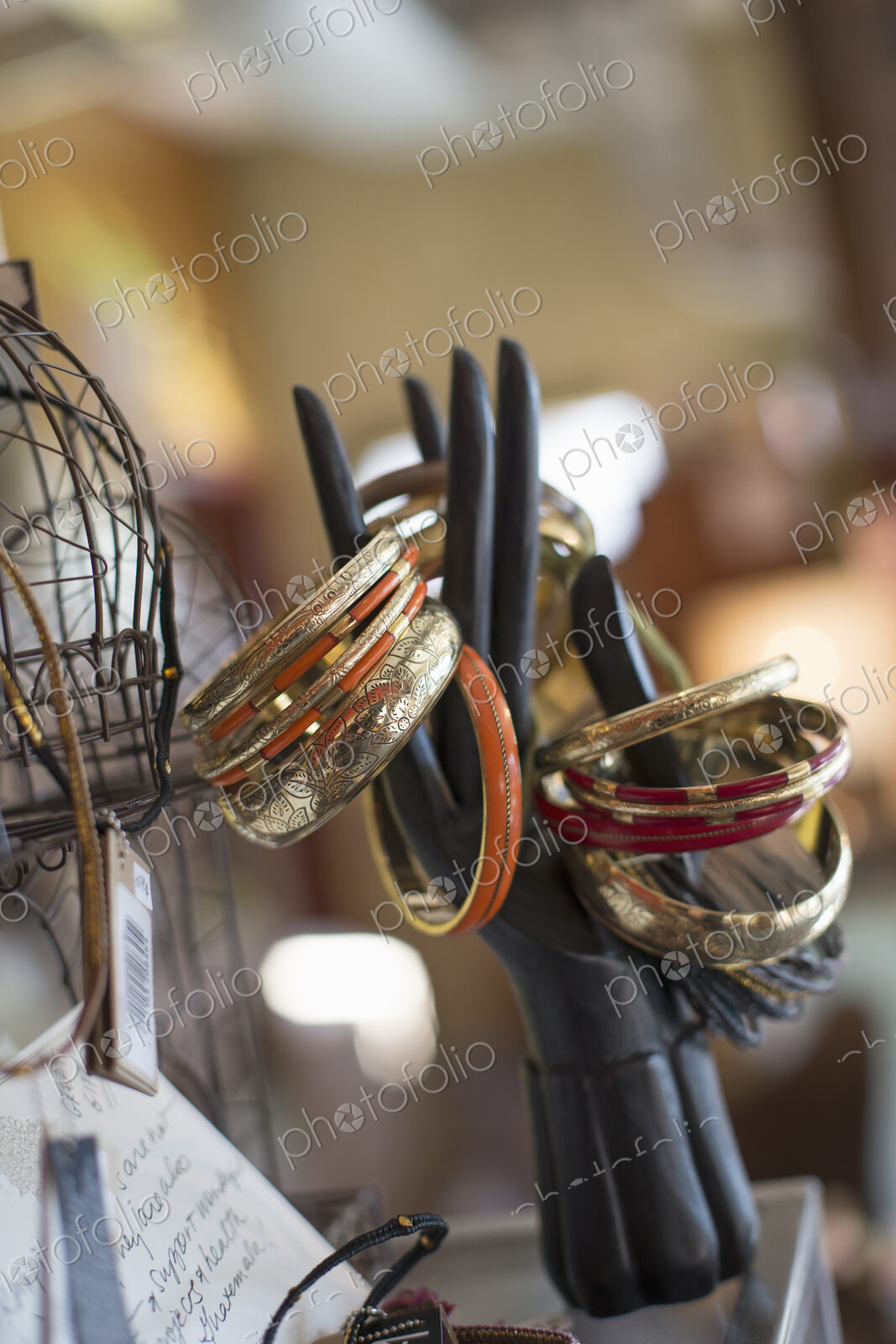 A display of rings and bangles, and objects in an antique store.