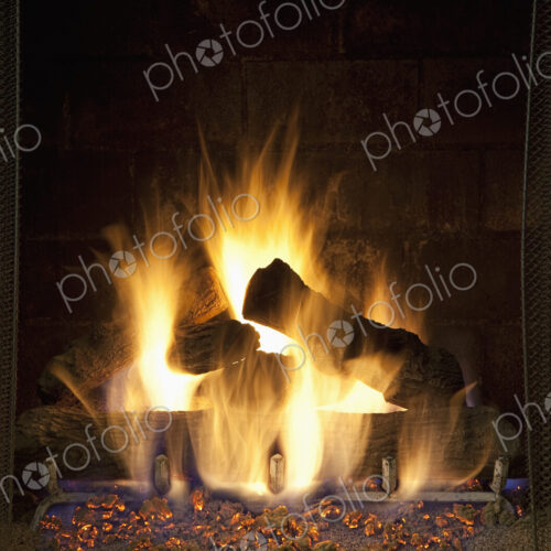 A domestic fireplace, hearth, fire lit, logs and flames. A domestic fireplace, hearth, fire lit, logs and flames.
