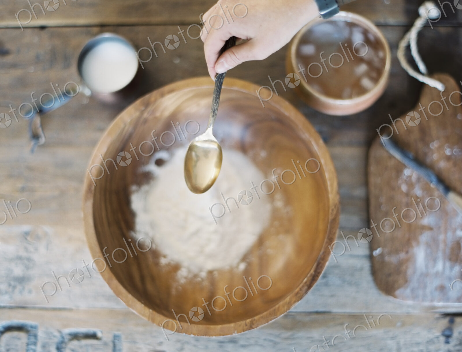 A domestic kitchen. A cook preparing a meal. A large bowl with oill and flour.…