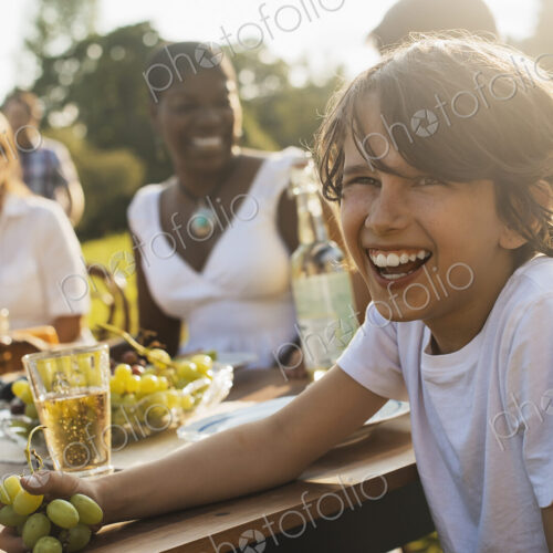 A family and friends having a meal outdoors. A picnic or buffet in the early evening. A family and friends having a meal outdoors. A picnic or buffet in the early evening.