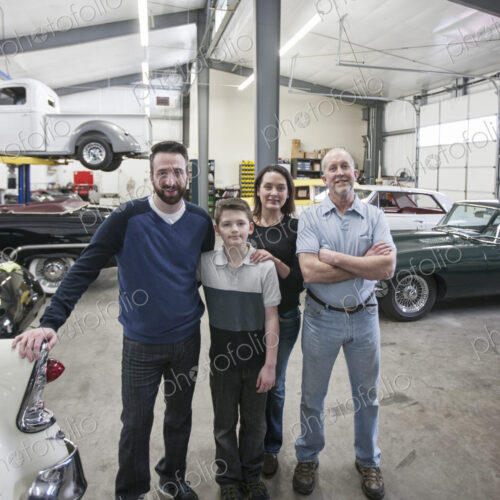 A family business, father, son and grandson, and a young woman posing in a classic car…
