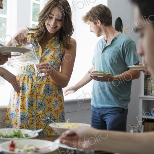 A family gathering for a meal. Adults and children around a table.