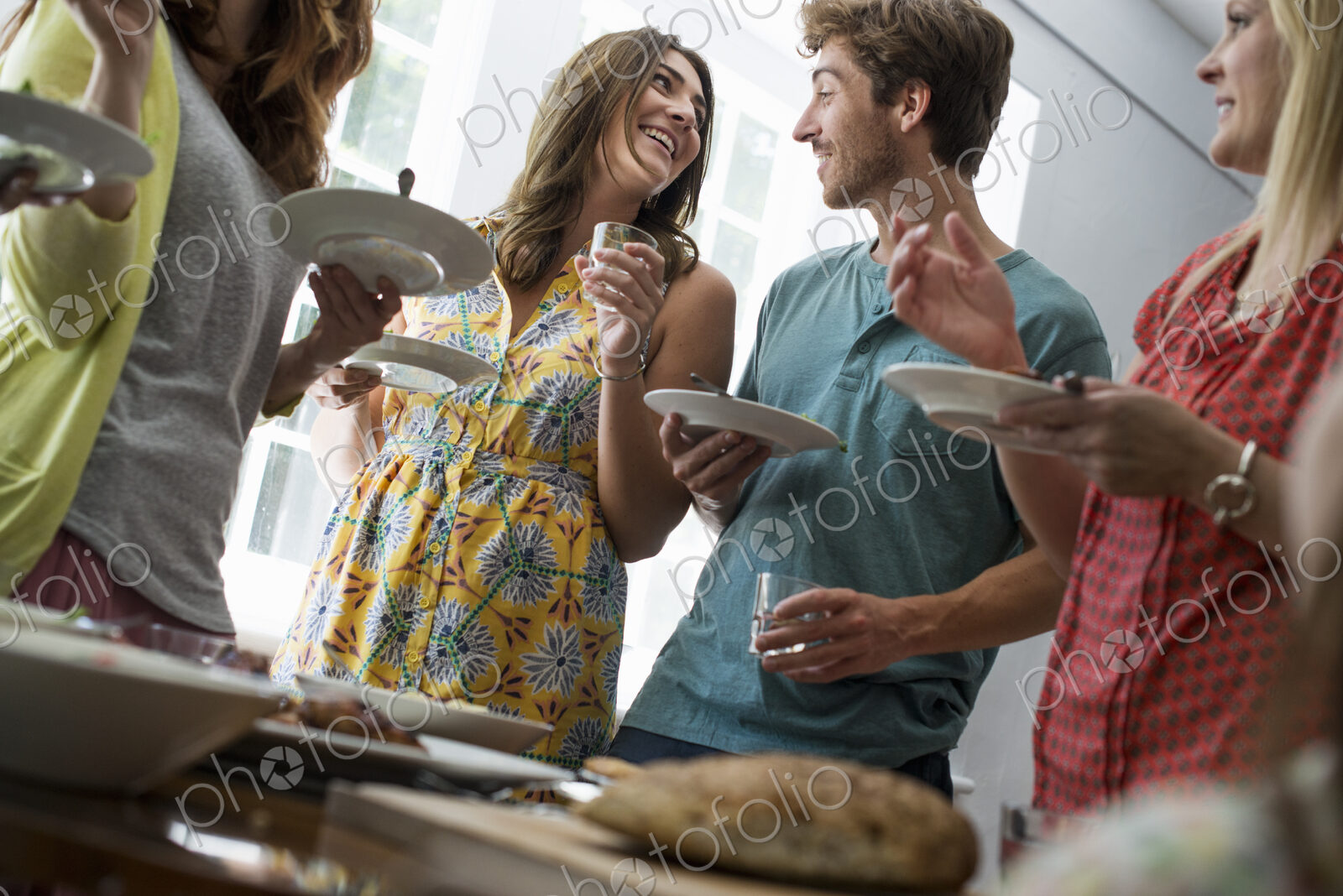 A family gathering for a meal. Adults and children around a table.