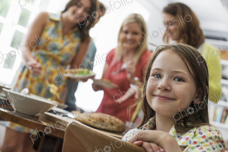 A family gathering for a meal. Adults and children around a table.