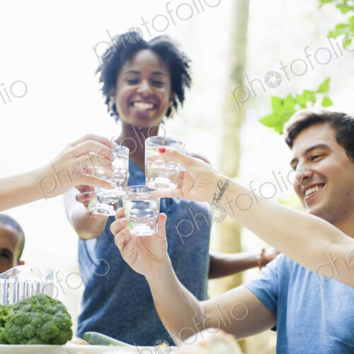A family gathering for a meal. Adults and children around a table.