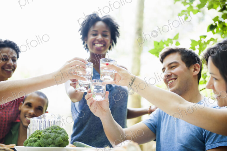 A family gathering for a meal. Adults and children around a table.