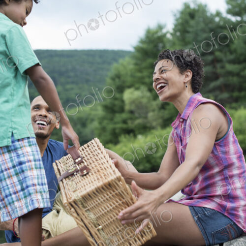 A family having a summer picnic at a lake.