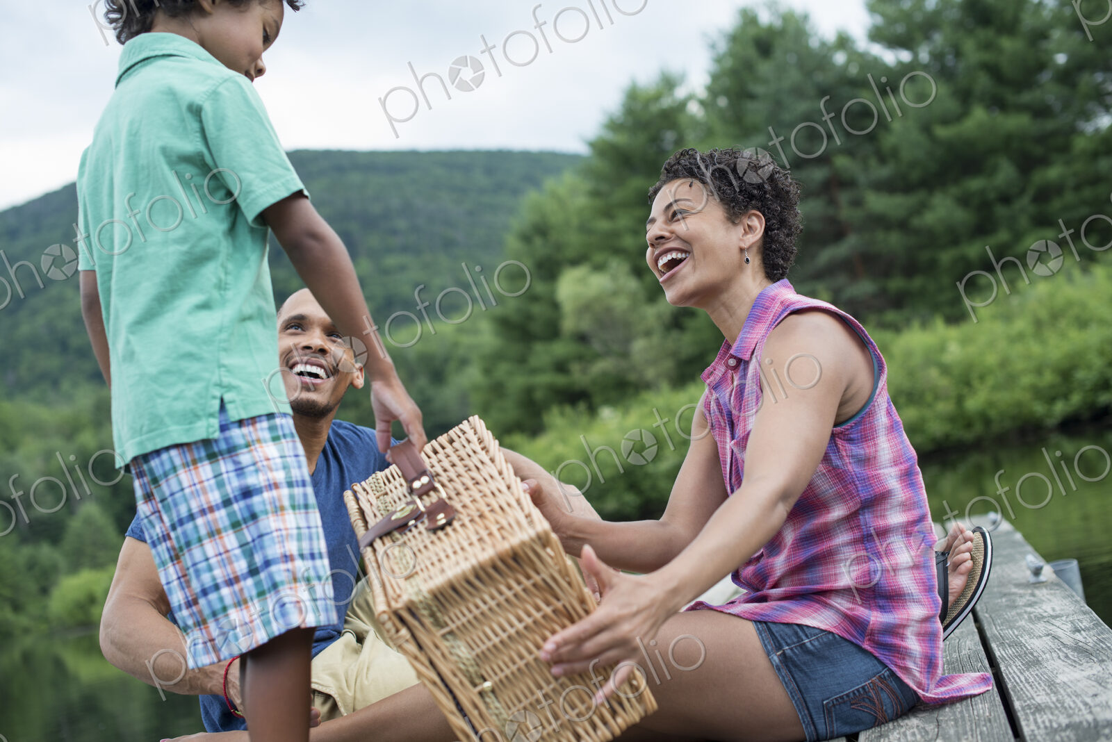 A family having a summer picnic at a lake.