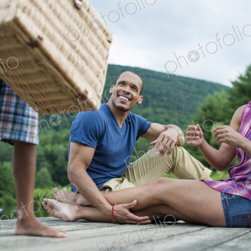 A family having a summer picnic at a lake.