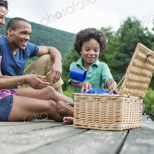 A family having a summer picnic at a lake.