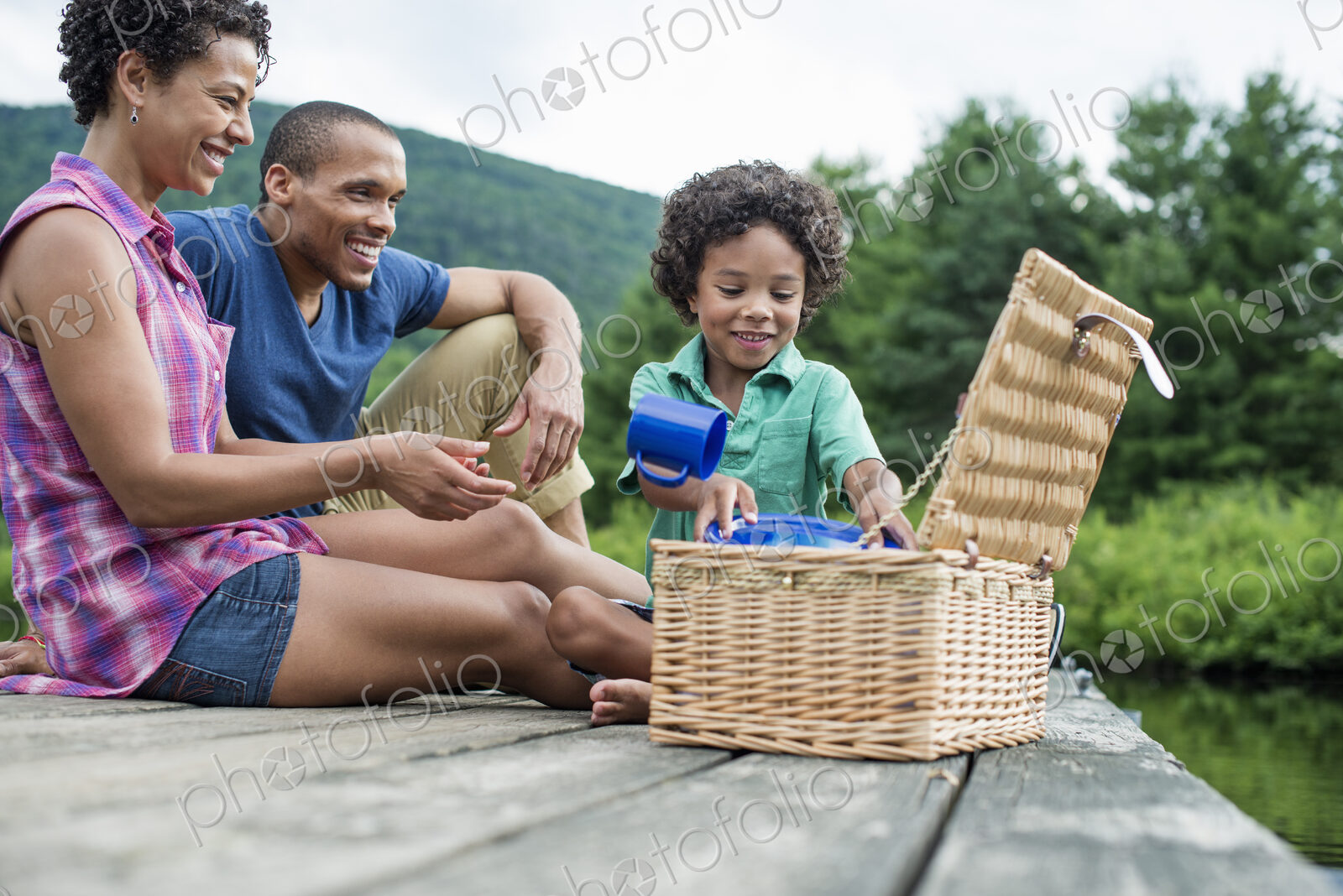 A family having a summer picnic at a lake.
