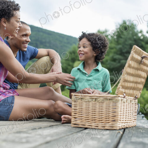 A family having a summer picnic at a lake.