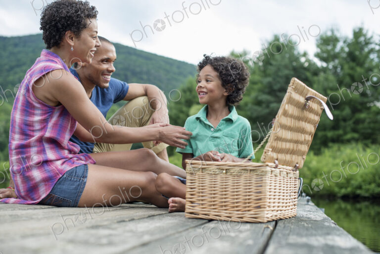 A family having a summer picnic at a lake.