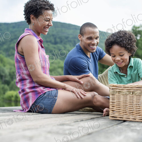 A family having a summer picnic at a lake.