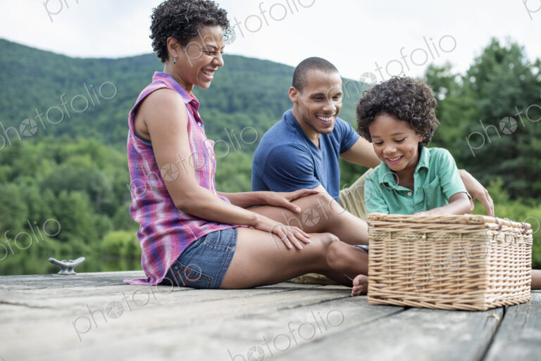 A family having a summer picnic at a lake.