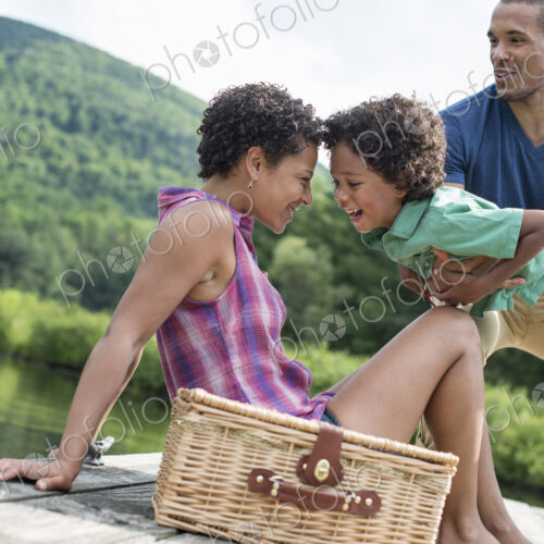 A family having a summer picnic at a lake. A family having a summer picnic at a lake.