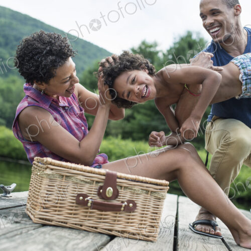 A family having a summer picnic at a lake.