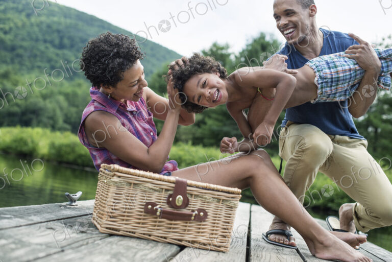 A family having a summer picnic at a lake.