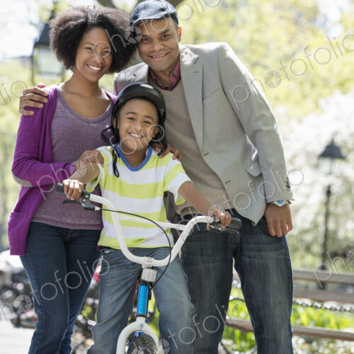 A family in the park on a sunny day. Bicycling and having fun. A family in the park on a sunny day. Bicycling and having fun.