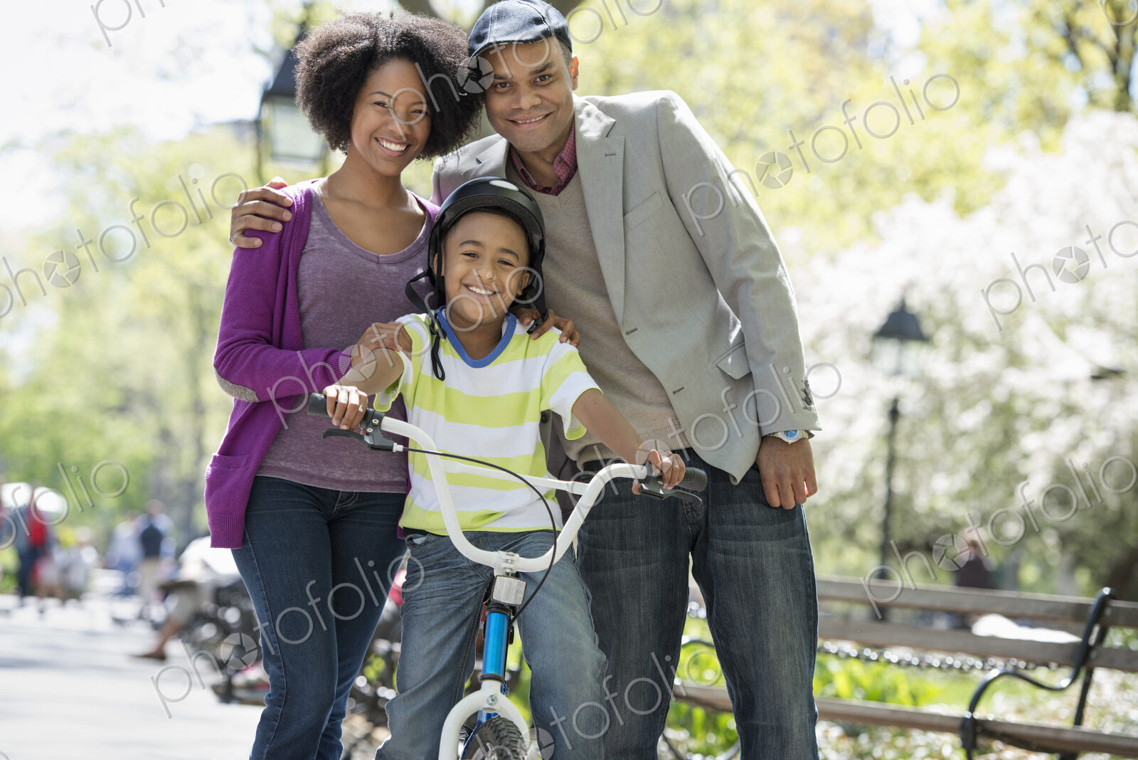 A family in the park on a sunny day. Bicycling and having fun.