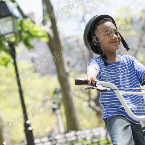A family in the park on a sunny day. Bicycling and having fun. A family in the park on a sunny day. Bicycling and having fun.