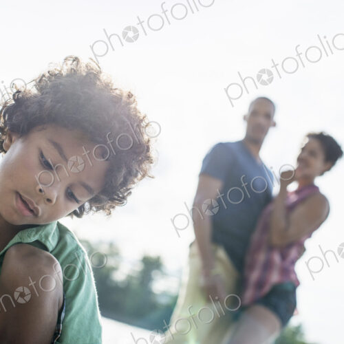 A family, parents and son spending time together by a lake in summer. A family, parents and son spending time together by a lake in summer.