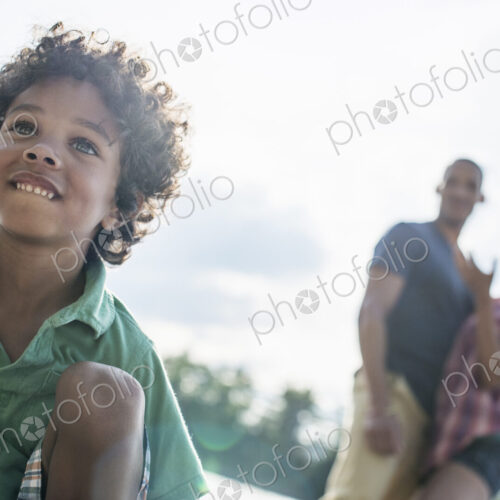 A family, parents and son spending time together by a lake in summer. A family, parents and son spending time together by a lake in summer.