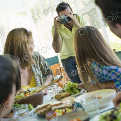 A family party around a table in a cafe. Adults and children. A family party around a table in a cafe. Adults and children.