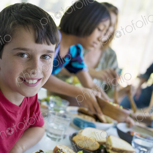 A family party around a table in a cafe. Adults and children. A family party around a table in a cafe. Adults and children.