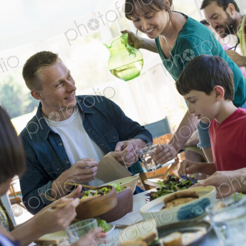 A family party around a table in a cafe. Adults and children. A family party around a table in a cafe. Adults and children.