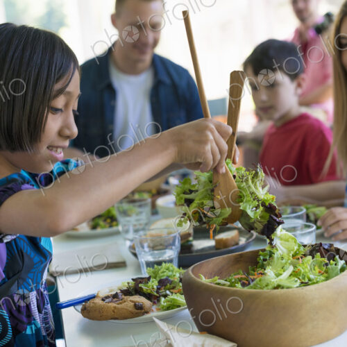 A family party around a table in a cafe. Adults and children. A family party around a table in a cafe. Adults and children.