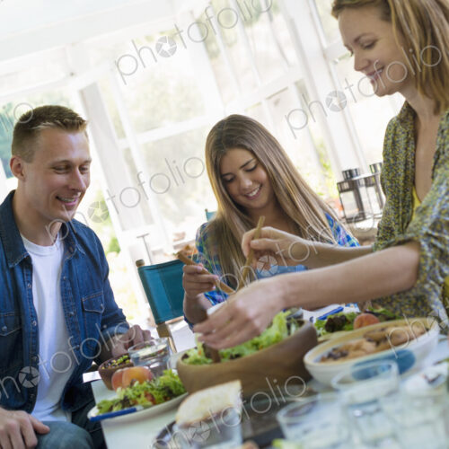 A family party around a table in a cafe. Adults and children. A family party around a table in a cafe. Adults and children.