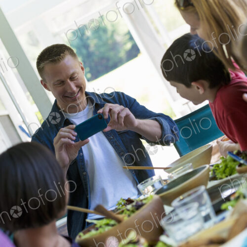 A family party around a table in a cafe. Adults and children. A family party around a table in a cafe. Adults and children.