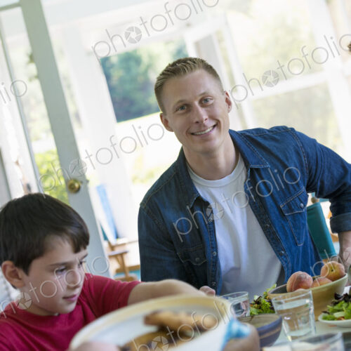 A family party around a table in a cafe. Adults and children. A family party around a table in a cafe. Adults and children.