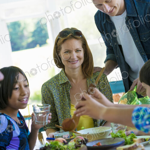A family party around a table in a cafe. Adults and children. A family party around a table in a cafe. Adults and children.
