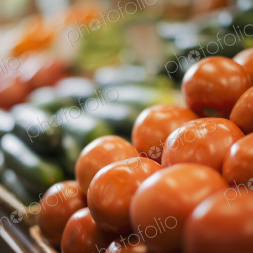 A farm stand display of fresh produce. Tomatoes and cucumbers. A farm stand display of fresh produce. Tomatoes and cucumbers.