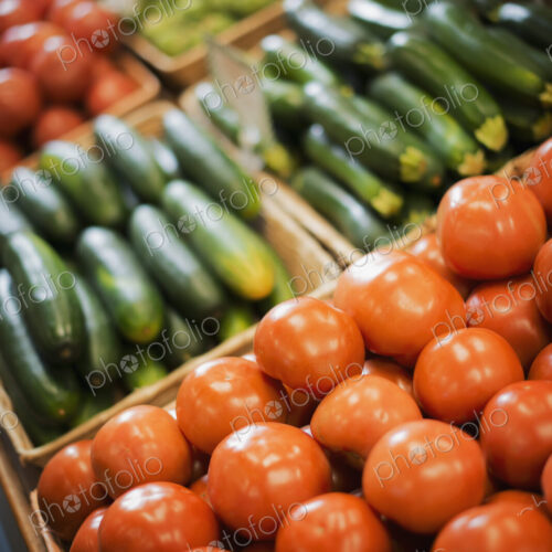 A farm stand display of organic vegetables. Produce. tomatoes and cucumbers. A farm stand display of organic vegetables. Produce. tomatoes and cucumbers.