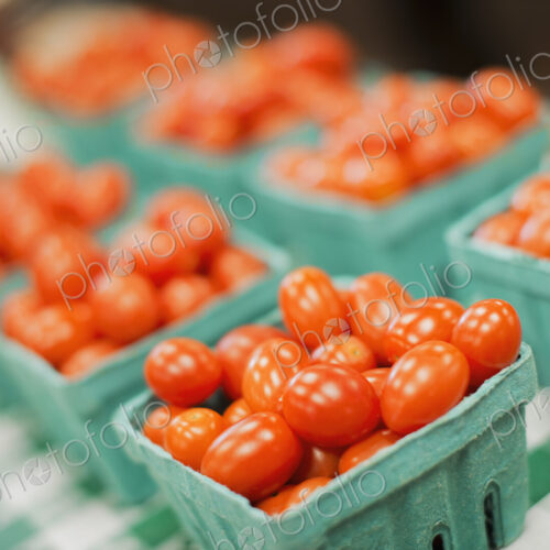 A farm stand. Green boxes of tomatoes. A farm stand. Green boxes of tomatoes.