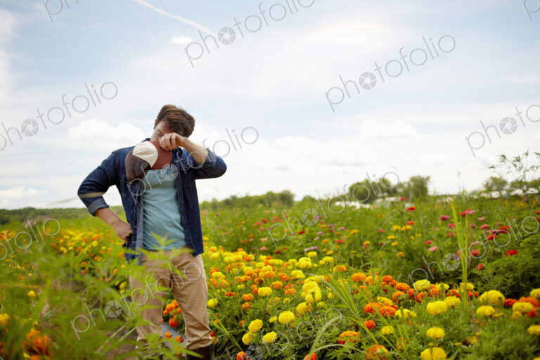 A farmer working in his fields in New York State. A yellow and orange organically…