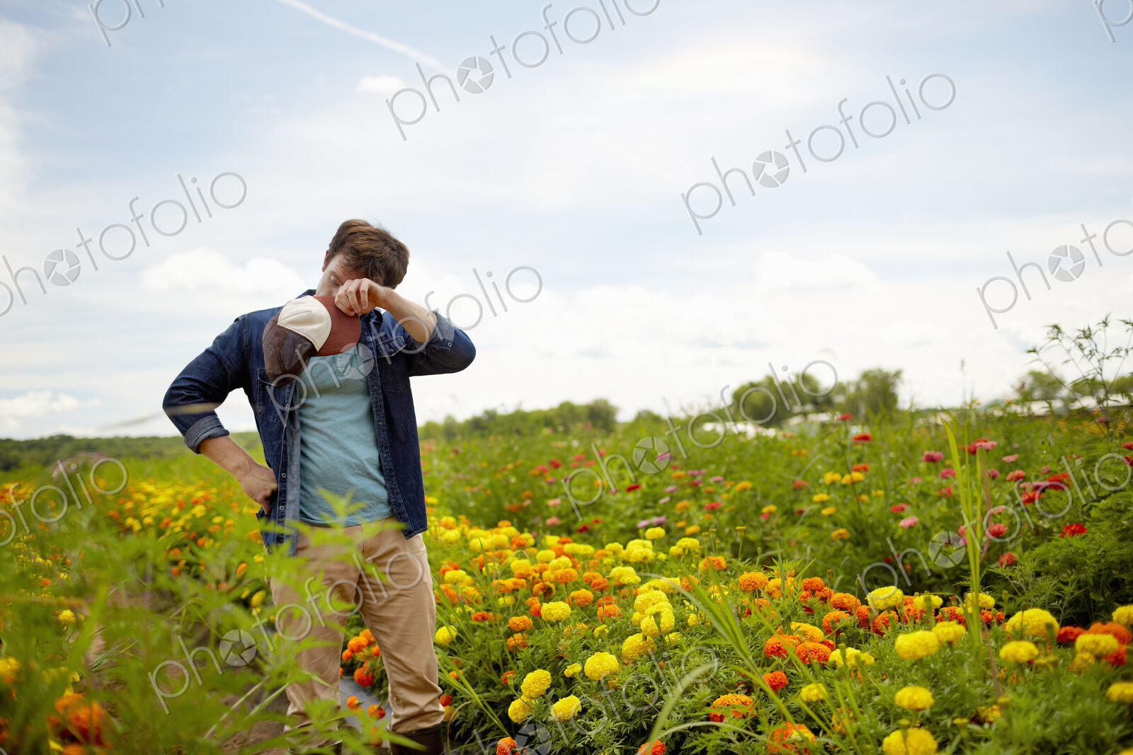 A farmer working in his fields in New York State. A yellow and orange organically…