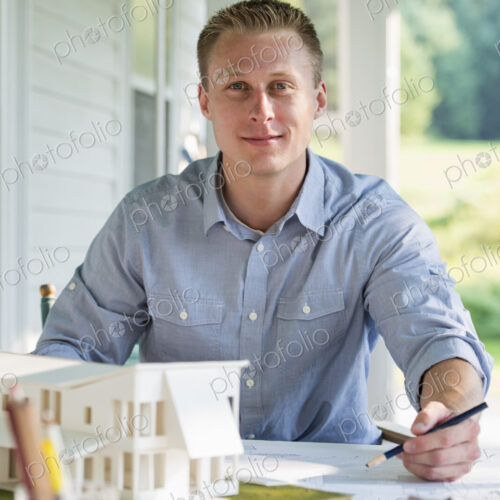 A farmhouse kitchen. A model of a house on the table. Designing a house. A farmhouse kitchen. A model of a house on the table. Designing a house.