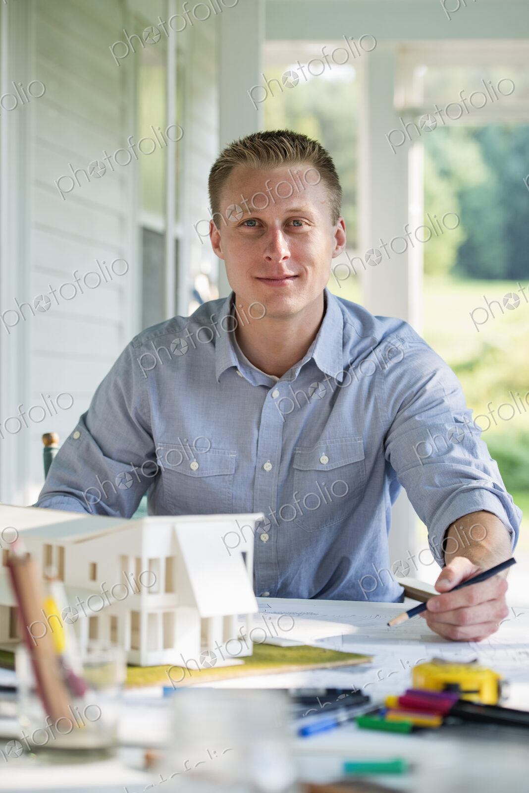 A farmhouse kitchen. A model of a house on the table. Designing a house.