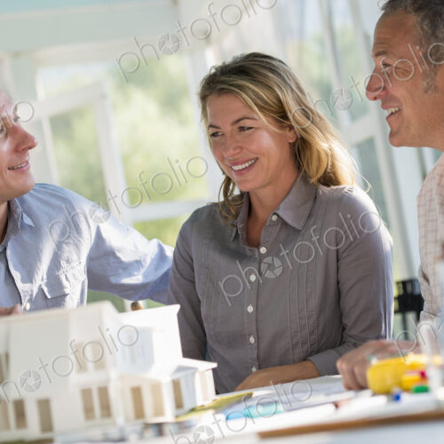 A farmhouse kitchen. A model of a house on the table. Planning and designing a house…