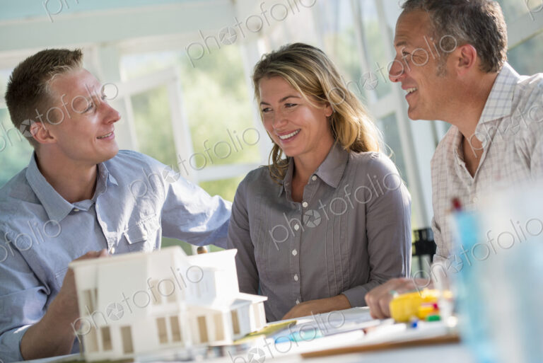 A farmhouse kitchen. A model of a house on the table. Planning and designing a house…