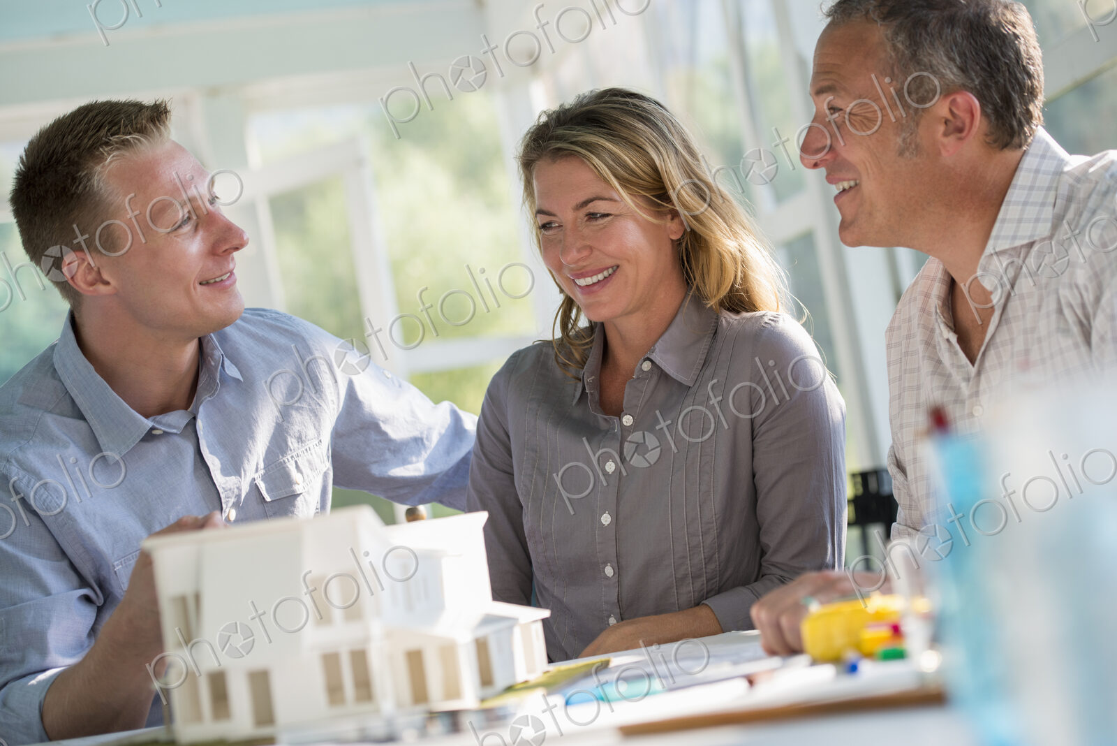 A farmhouse kitchen. A model of a house on the table. Planning and designing a house…