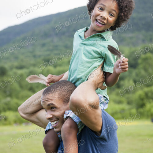 A father lifting his son up onto his shoulders. A father lifting his son up onto his shoulders.