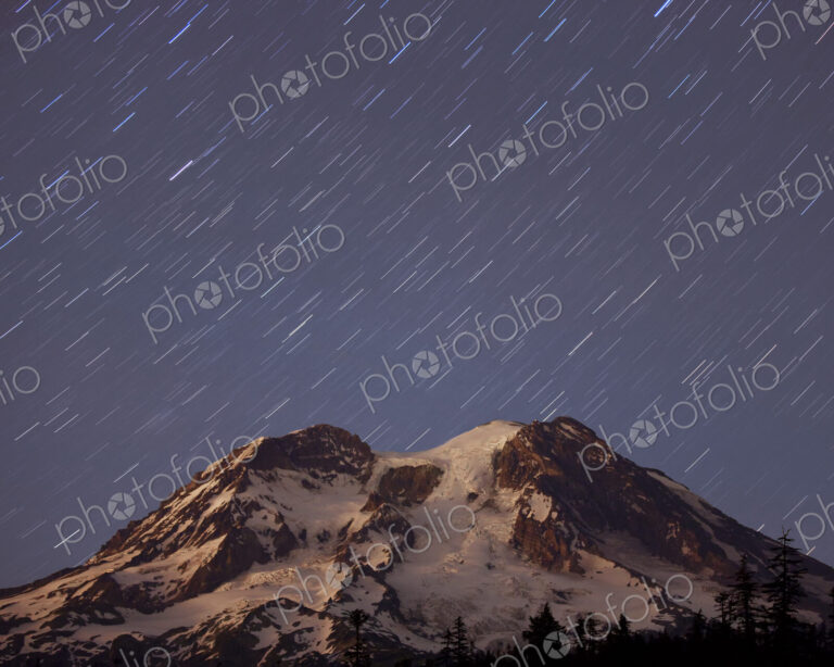 A five minute timed exposure of the night sky and a shower of stars above Mount…